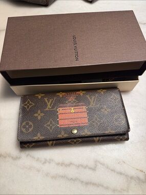 Louis Vuitton Monogram Continental Wallet with Red Trunk Motif. Comes with COA